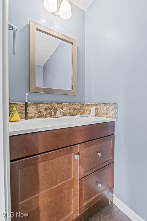 bathroom with hardwood / wood-style floors and vanity