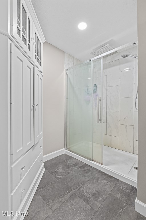 bathroom featuring a shower with door