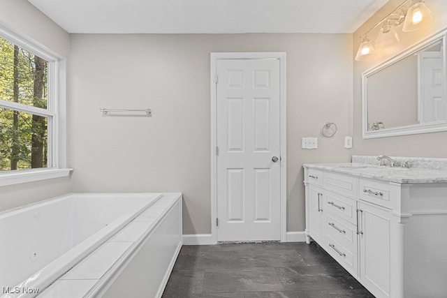 bathroom with a bathing tub and vanity