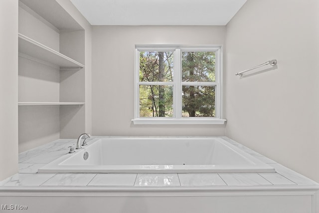 bathroom featuring a tub to relax in