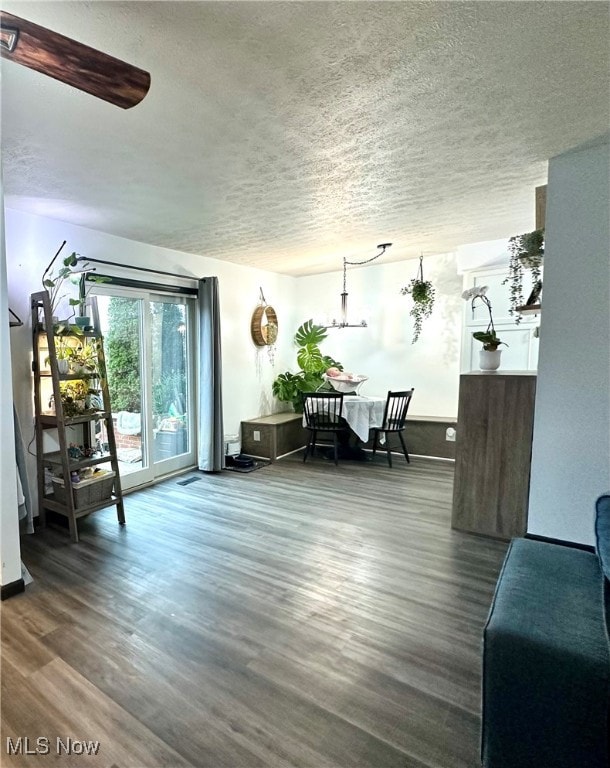 interior space with wood-type flooring and a textured ceiling