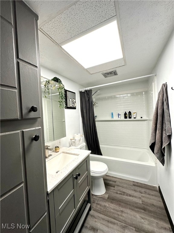 full bathroom featuring toilet, vanity, shower / bath combination with curtain, and hardwood / wood-style flooring