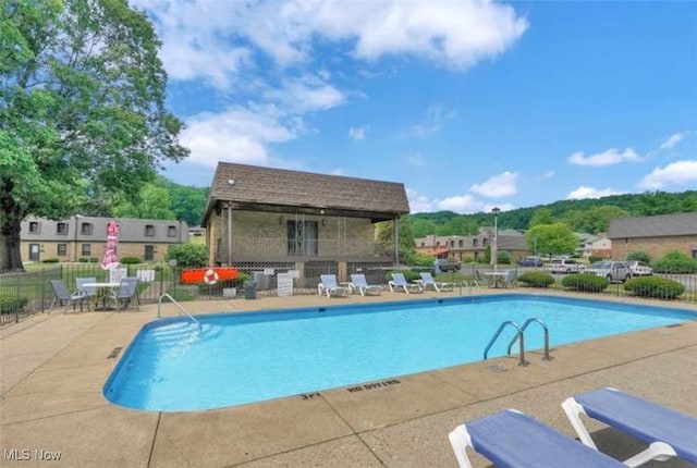 view of swimming pool with a patio area