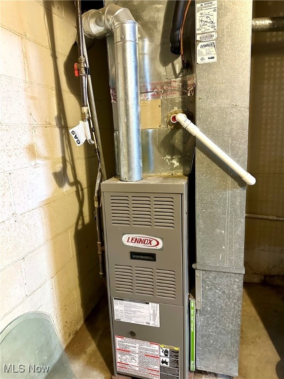 utility room featuring heating unit