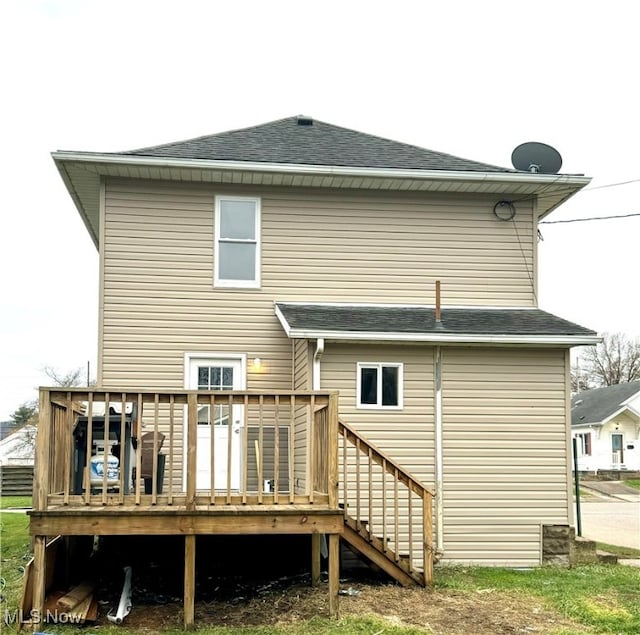 back of property featuring a deck