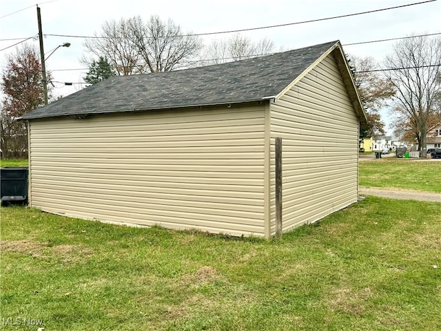 view of outbuilding with a yard