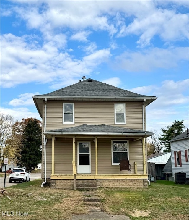 view of front of home featuring a porch, central air condition unit, and a front lawn