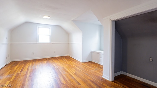 bonus room featuring light hardwood / wood-style flooring and lofted ceiling