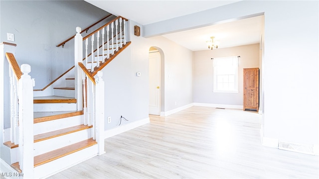 stairs featuring beamed ceiling and hardwood / wood-style flooring