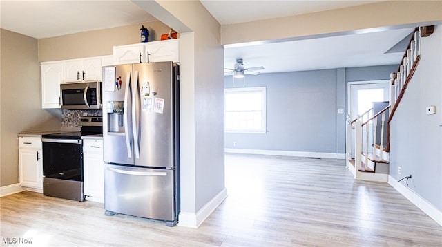 kitchen featuring white cabinetry, ceiling fan, stainless steel appliances, backsplash, and light hardwood / wood-style floors