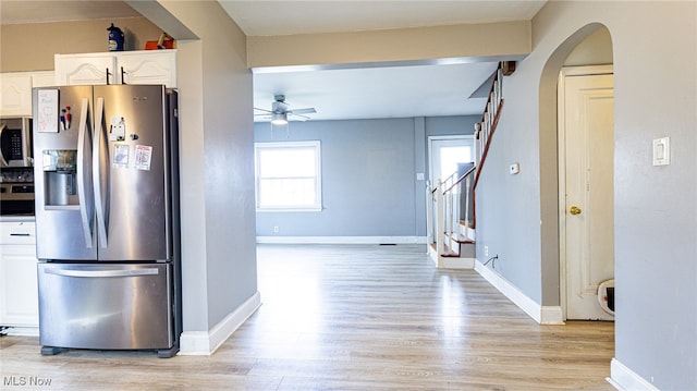 kitchen featuring white cabinets, ceiling fan, light hardwood / wood-style floors, and appliances with stainless steel finishes