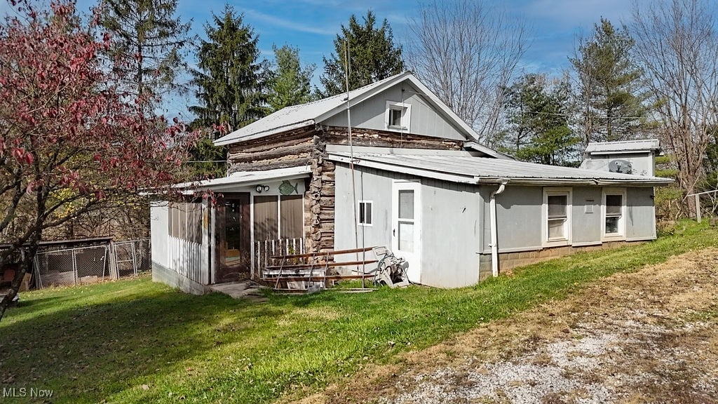 rear view of property with a yard