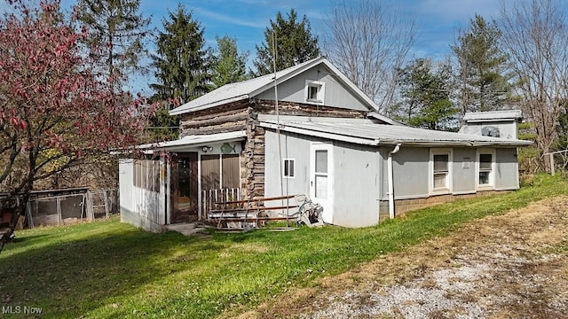 rear view of property with a yard