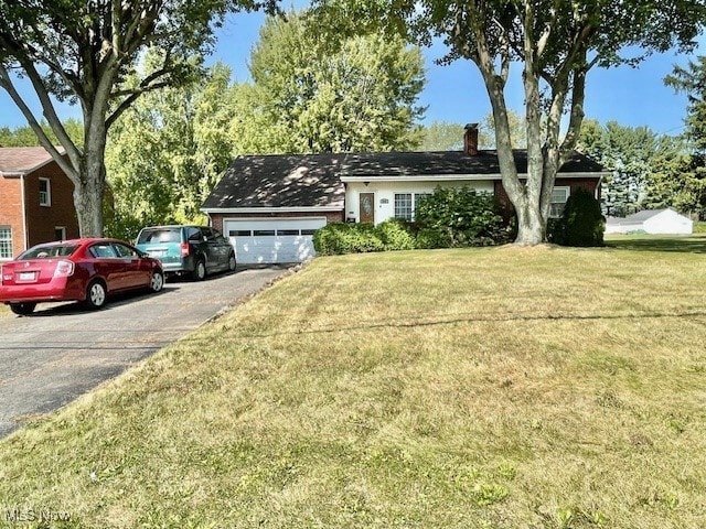 ranch-style house with a front lawn and a garage