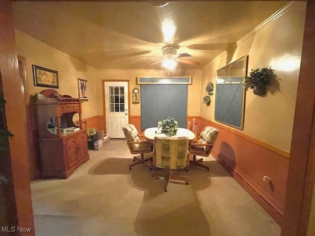 carpeted dining room with ceiling fan