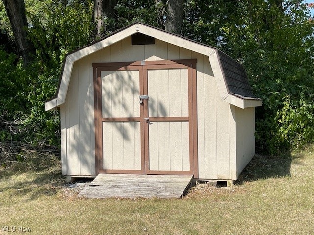 view of outbuilding featuring a lawn