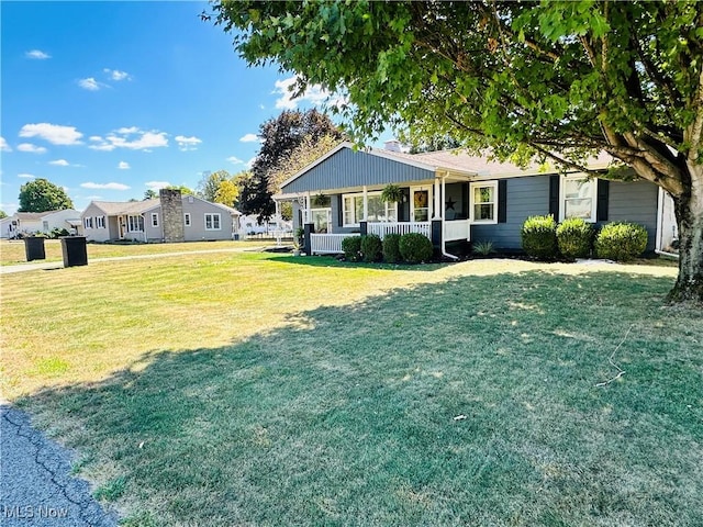 ranch-style house with a front yard and a porch