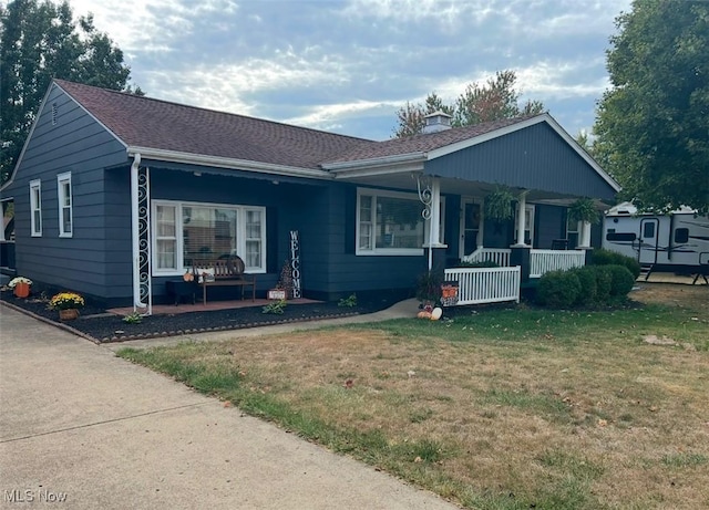 ranch-style house with a porch and a front yard