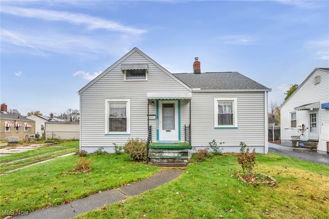 bungalow-style house with a front lawn