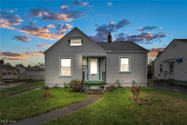 bungalow-style home featuring a lawn