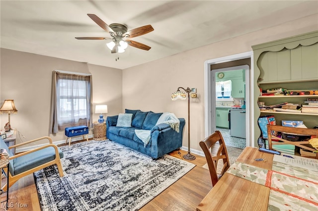 living room featuring light hardwood / wood-style flooring, plenty of natural light, and ceiling fan