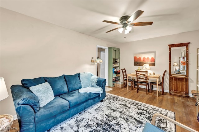 living room with ceiling fan and hardwood / wood-style floors