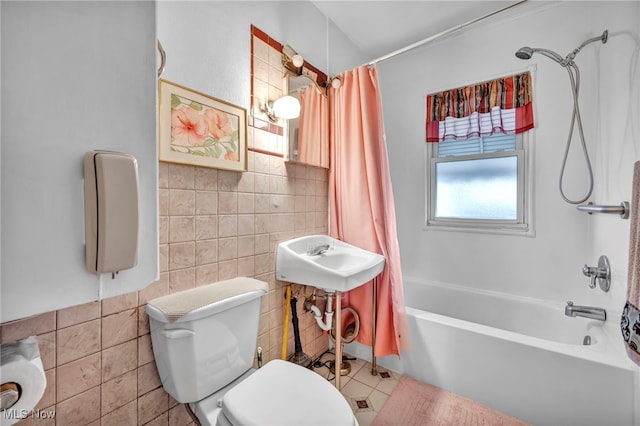 bathroom featuring shower / tub combo, toilet, tile walls, and tile patterned floors