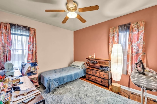 bedroom with ceiling fan and hardwood / wood-style floors