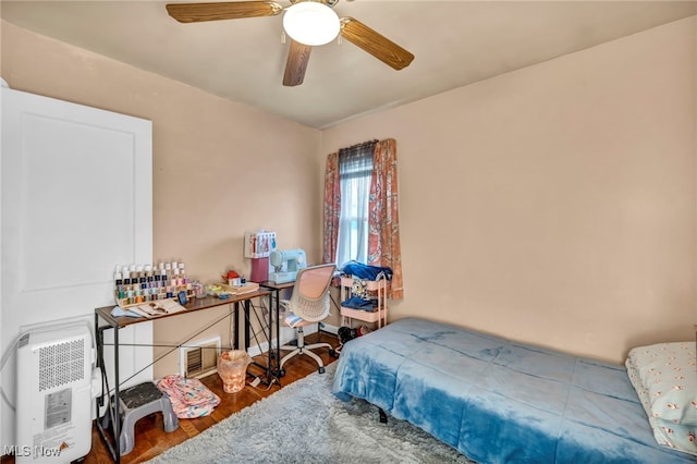 bedroom with hardwood / wood-style floors and ceiling fan