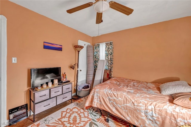 bedroom with hardwood / wood-style flooring and ceiling fan