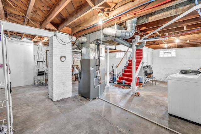 basement with washer and dryer and heating unit