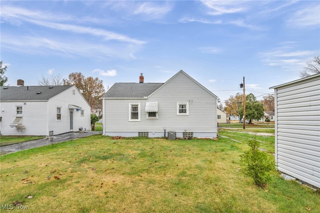 rear view of property featuring a yard