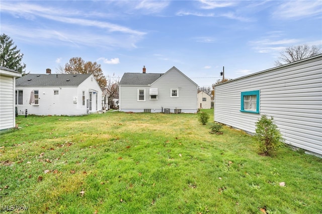 rear view of property featuring a yard