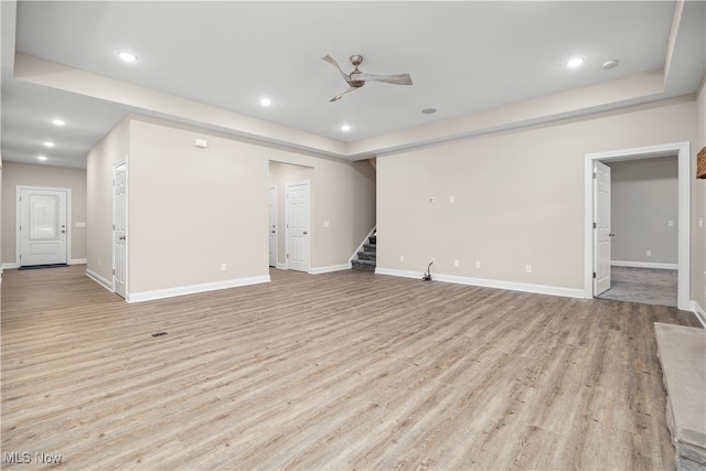 unfurnished living room featuring light wood-type flooring and ceiling fan