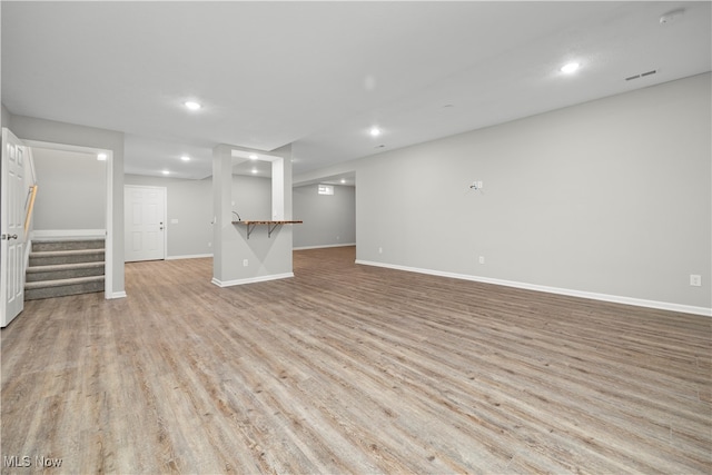 unfurnished living room with light hardwood / wood-style flooring