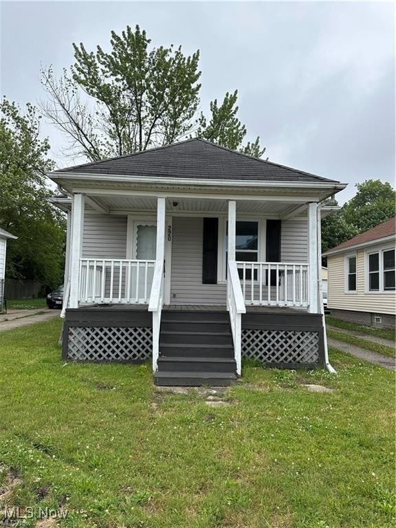 bungalow with a front yard and a porch