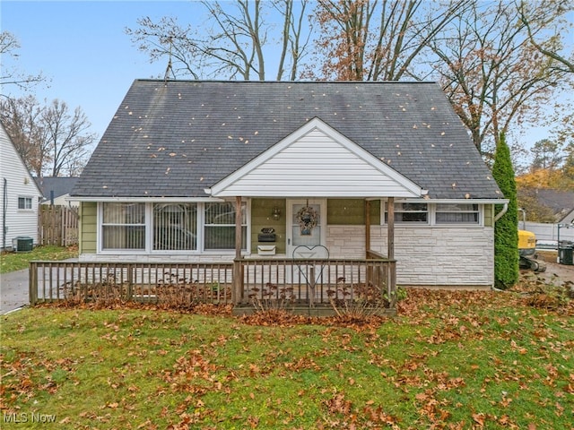 bungalow-style house featuring a front yard and cooling unit