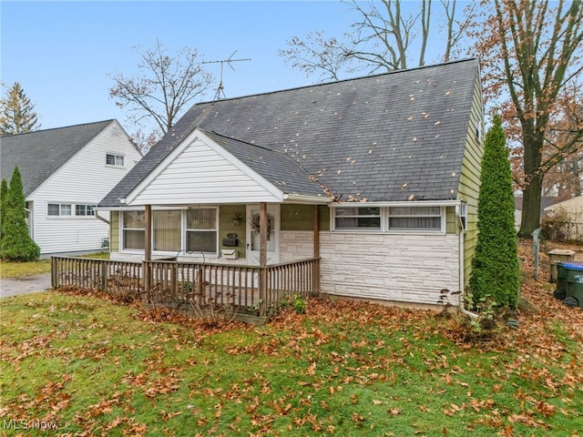 rear view of house with a lawn