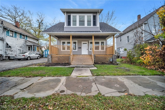 bungalow featuring a front lawn and a porch