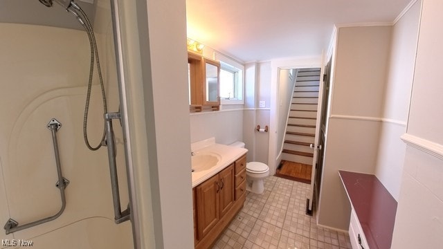 bathroom featuring vanity, toilet, and walk in shower