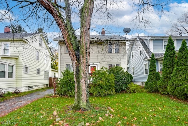 rear view of house with a lawn