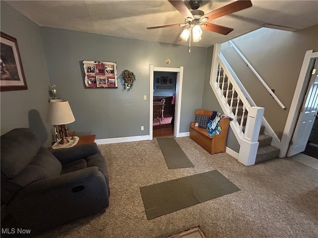 carpeted living room with ceiling fan