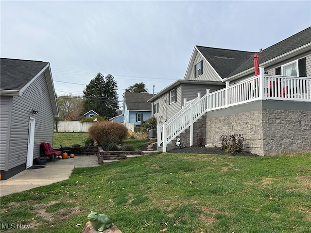 view of home's exterior with a lawn and a patio