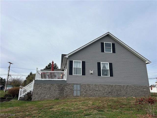 view of property exterior with a lawn