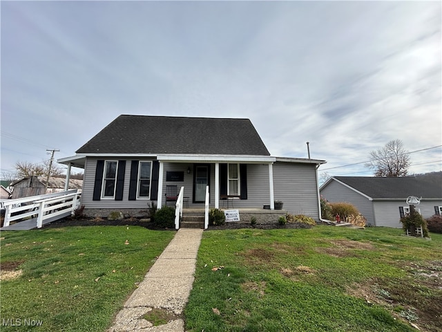 view of front of home with a front yard and a porch