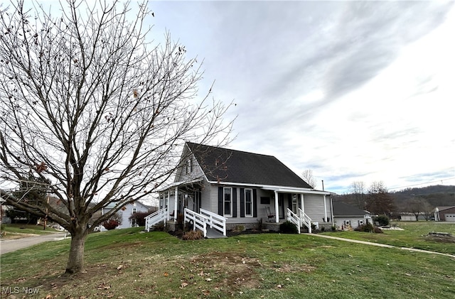 view of front of home with covered porch and a front lawn