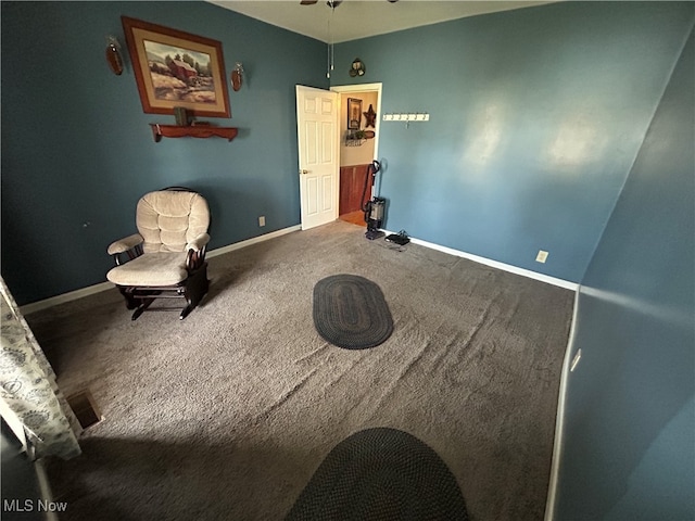 sitting room with carpet flooring and ceiling fan