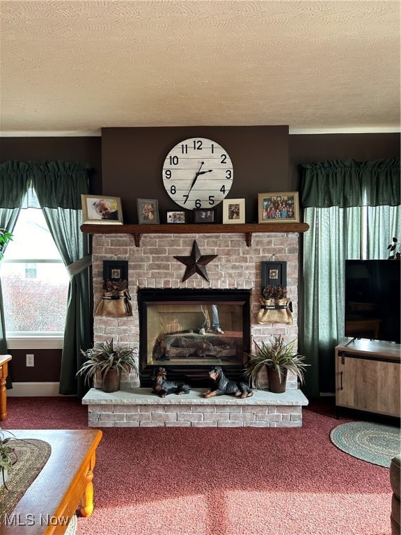 living room featuring carpet, a textured ceiling, and a brick fireplace