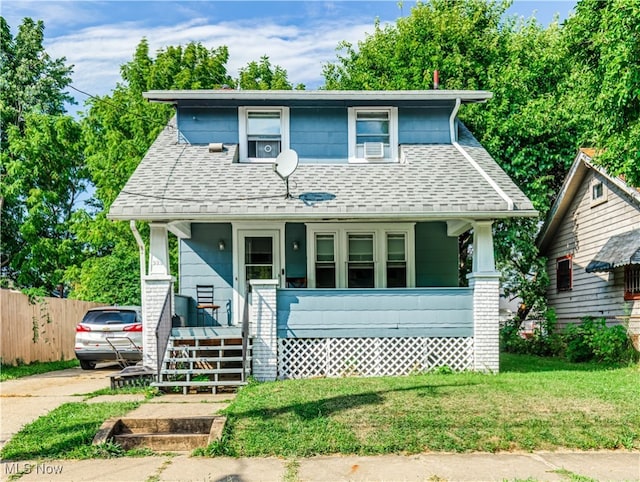 view of front of house with a porch and a front yard