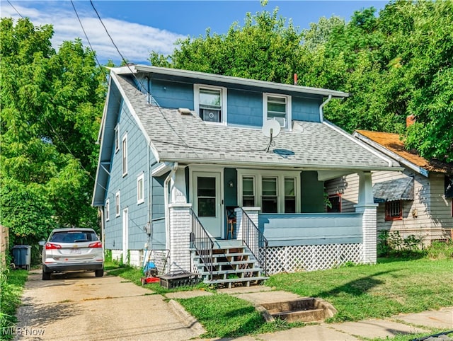 view of front of property with covered porch and a front lawn